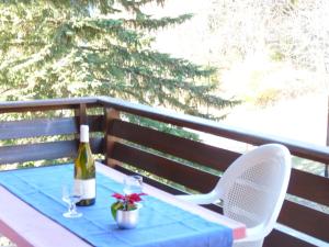 a table with a bottle of wine and two glasses at Apartment Tourbillon A 27 by Interhome in Ovronnaz