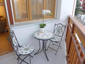 a small table and two chairs on a balcony at Apartment Barzettes-Vacances 553 - Entrée N- 14 by Interhome in Vermala
