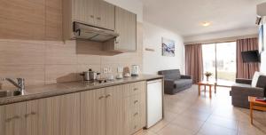 a kitchen with a sink and a counter top at Penelope Beach Hotel Apts in Protaras