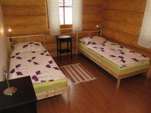 a bedroom with two beds in a log cabin at Chalet Lazny by Interhome in Pohorsko