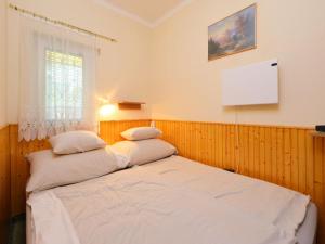 A bed or beds in a room at Holiday Home Piccola by Interhome