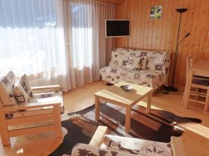 een woonkamer met een bank en een tafel bij Studio Sources 4109 by Interhome in Ovronnaz