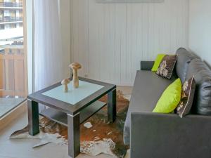 a living room with a couch and a coffee table at Studio Grenier 5 by Interhome in Nendaz