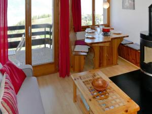 a living room with a couch and a table at Apartment Foret E3 by Interhome in Nendaz