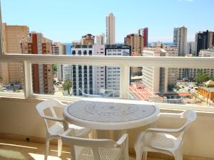 a table and chairs on a balcony with a view of a city at Apartment Gemelos by Interhome in Benidorm