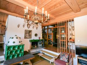 a living room with a fireplace and a chandelier at Holiday Home Berghaus Weitblick by Interhome in Ramsau am Dachstein +35 photos