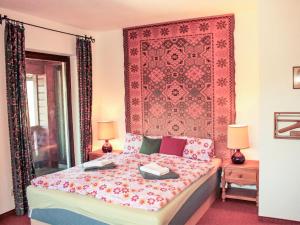 a bedroom with a bed with a red wall at Holiday Home Berghaus Weitblick by Interhome in Ramsau am Dachstein