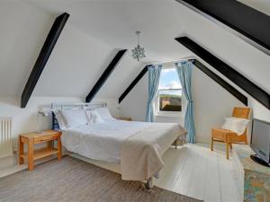 a bedroom with a large bed and a window at Holiday Home Albert by Interhome in Fowey