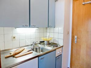 a kitchen with a sink and a counter top at Studio La Bercière 7 by Interhome in Villars-sur-Ollon