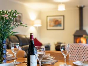 アベルダロンにあるHoliday Home Glandoris by Interhomeのワイングラス付きのテーブルに座ったワイン1本