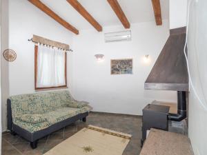 a living room with a couch and a stove at Holiday Home Sibilla by Interhome in Pedrumalu