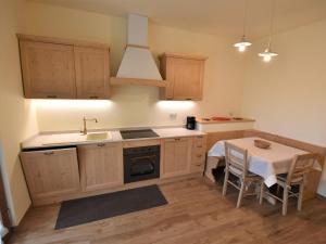 kuchnia ze stołem, zlewem i kuchenką w obiekcie Apartment Elettra-7 by Interhome w mieście Crone