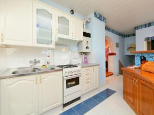 a kitchen with white cabinets and a sink at Apartment Cabernet by Interhome in Balatonszemes +5 photos