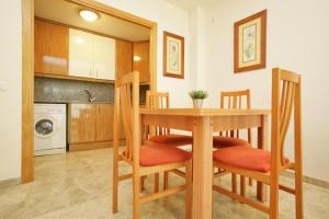 a kitchen with a table and chairs in a kitchen at Rentalmar Ventura Village in Salou