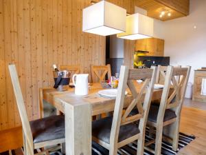 a dining room with a wooden table and chairs at Apartment Regina B9 by Interhome in Villars-sur-Ollon +28 photos