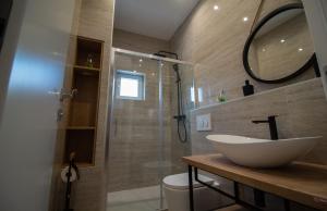 a bathroom with a sink and a shower at Apartments Dalmatino in Kaštela