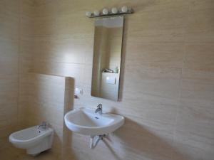 a bathroom with a sink and a mirror at Villa AnnaLia - Rooms to Rent in Bacău