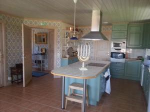 a kitchen with a table with a candle on it at Kullsbjörken Bed & Breakfast in Tällberg