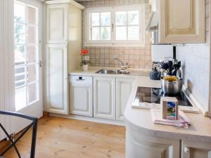 a kitchen with white cabinets and a sink at Apartment Savoie 1 by Interhome in Villars-sur-Ollon