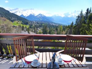 a table and chairs on a balcony with mountains at Apartment Savoie 1 by Interhome in Villars-sur-Ollon