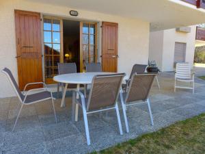 a table and chairs sitting on a patio at Apartment Le Miclivier B1 by Interhome in Villars-sur-Ollon