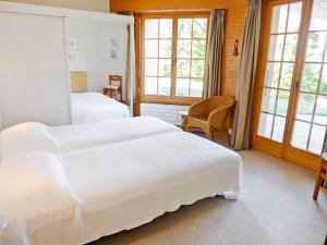 a bedroom with two beds and a table and chairs at Apartment Le Miclivier B1 by Interhome in Villars-sur-Ollon +20 photos