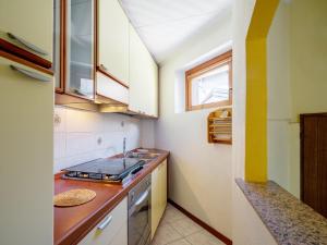 a small kitchen with a sink and a stove at Holiday Home La mia Casetta by Interhome in Porto Valtravaglia