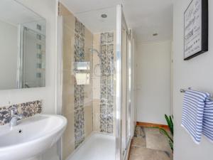 a bathroom with a white sink and a shower at Holiday Home Pebbles- Marazion by Interhome in Marazion
