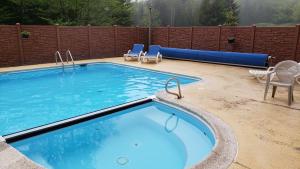 a large swimming pool with chairs and an inflatable at Silver Creek Unit 5404, Ski in-out, Pool Hot Tub in Snowshoe