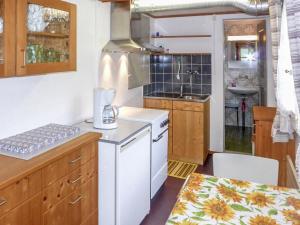 a kitchen with a white stove and a sink at Apartment Chalet Chilchboden by Interhome in Grindelwald