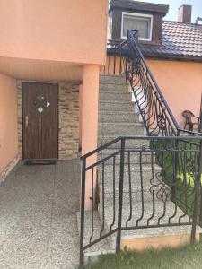 a staircase leading to a house with a wooden door at Superubytovanie Olga in Štrba