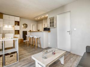 a living room and kitchen with a table and a couch at Apartment Port Arcachon-1 by Interhome in Arcachon