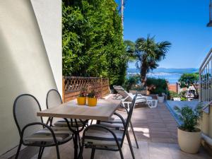 a patio with a table and chairs on a balcony at Holiday Home Bono by Interhome in Opatija