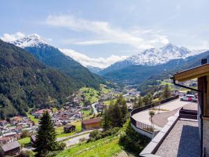 a view of a town with snow capped mountains at Apartment The PEAK-3 by Interhome in Sölden