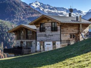 a log house on a hill with mountains in the background at Studio The PEAK-8 by Interhome in Sölden