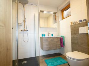 a bathroom with a shower and a toilet and a sink at Apartment Mundlers Hoamatl Top 1 by Interhome in Oetz