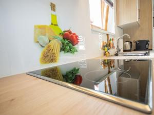 a kitchen counter with a sink with vegetables on it at Apartment Mundlers Hoamatl Top 1 by Interhome in Oetz