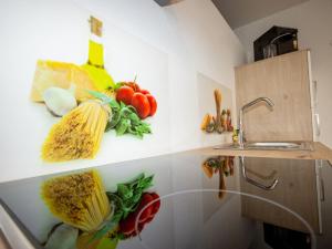 a kitchen with a bunch of vegetables on the wall at Apartment Mundlers Hoamatl-3 by Interhome in Oetz