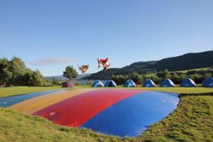 a kite flying in the sky over a field at Lillehammer Turistsenter Budget Hotel in Lillehammer