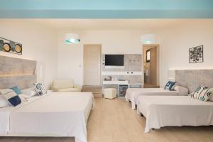 a hotel room with three beds and a tv at Hotel Ristorante La Conchiglia in Cala Gonone