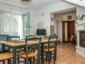 a dining room with a table and chairs and a fireplace at Holiday Home Sapphire by Interhome in Balatonmáriafürdő