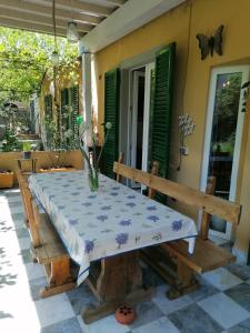 a table and a bench on a patio at Eco Pisa Tower Guesthouse in Pisa