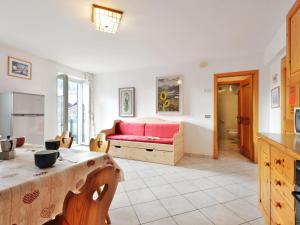 a living room with a bed and a table at Apartment Villa Placidia Apt 22 by Interhome in Campitello di Fassa