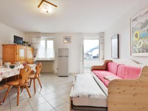 a living room with a couch and a table at Apartment Villa Placidia Apt 22 by Interhome in Campitello di Fassa
