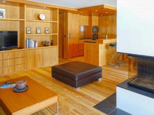 a living room with a couch and a tv at Apartment Bergere-2 by Interhome in Zermatt