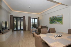 a dining room and living room with a table and chairs at App Prora Solitaire FeWo 8 Balkon, Strand, Wellness in Binz
