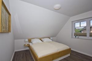 Katil atau katil-katil dalam bilik di Ferienhaus Zaunkönig FeWoOG - Balkon, Meerblick