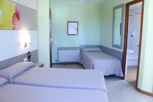 Un ou plusieurs lits dans un hébergement de l'établissement Hotel Sabiote