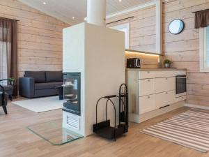 a room with a kitchen and a living room at Holiday Home Viherlaakso a by Interhome in Tahkovuori