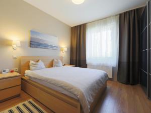 a bedroom with a large bed and a window at Villa Aschbacher by Interhome in Balatonszemes